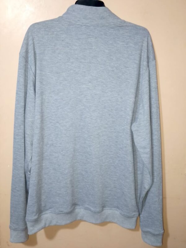 Buso cuello alto unicolor con cortes en contraste, silueta regular fit