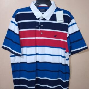 Polo para hombre, cuello maquina, manga corta, silueta regular, sin bolsillo, estructura con bloques de colores en tonos que se combinan